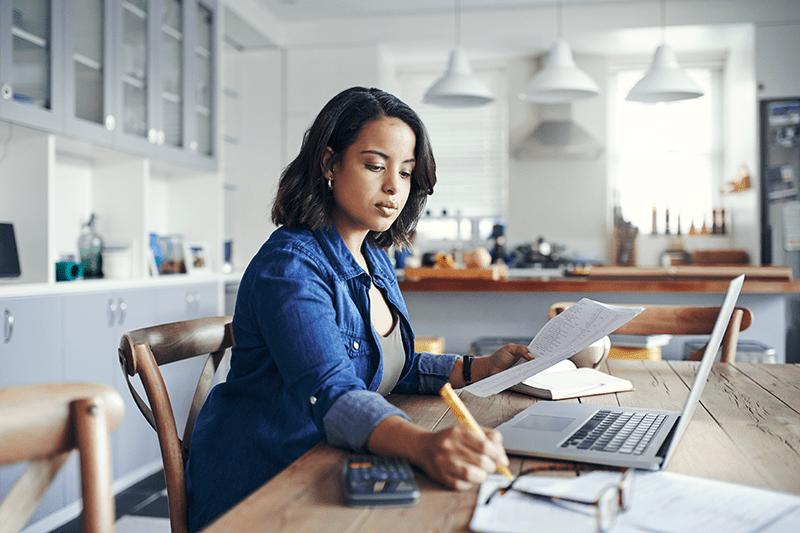 Woman documenting her utility bills.