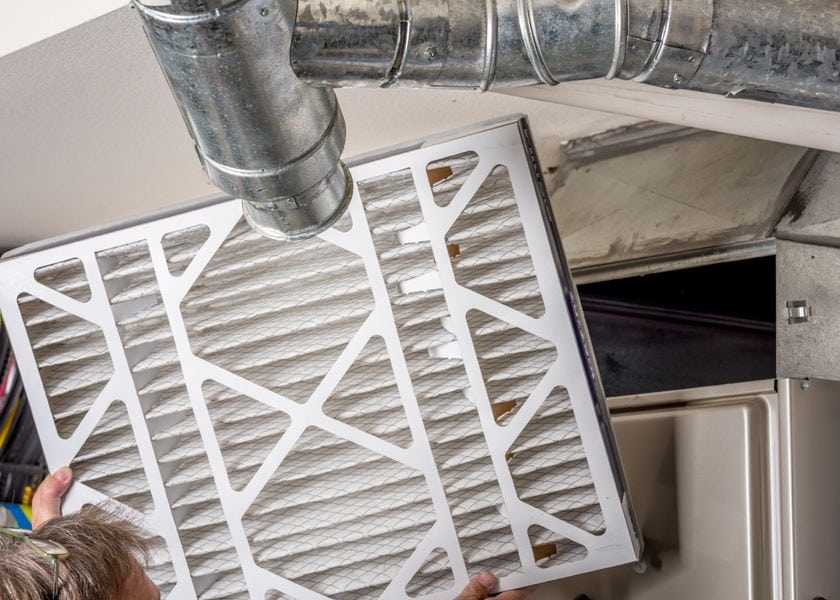 What Are Furnace Filters? Image shows filter being changed in furnace.